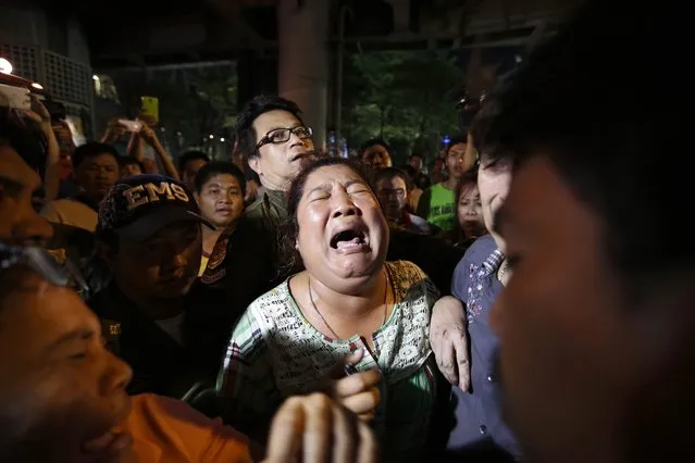 Persons search for missing relatives at the scene of an explosion near Erawan Shrine, central Bangkok, Thailand, 17 August 2015. (Photo by Ritchie B. Tongo/EPA)