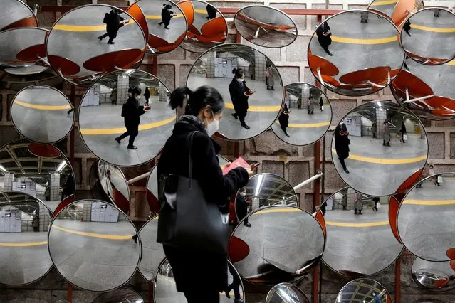 A woman wearing a mask to prevent the coronavirus is reflected in the mirrors, in Seoul, South Korea, February 24, 2020. (Photo by Heo Ran/Reuters)