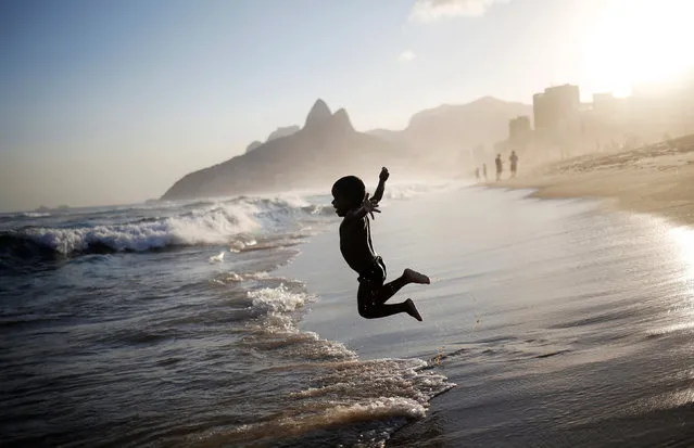 A boy jumps on Ipanema beach in Rio de Janeiro, Brazil, May 3, 2016. (Photo by Nacho Doce/Reuters)