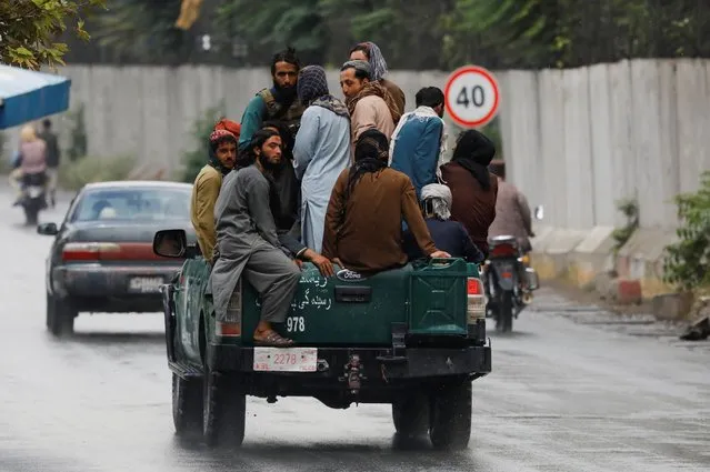 Taliban fighters drive a car on a street following the killing of Al Qaeda leader Ayman al-Zawahiri in a U.S. strike over the weekend, in Kabul, Afghanistan on August 2, 2022. (Photo by Ali Khara/Reuters)