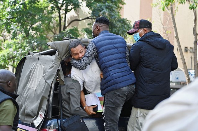 Executive Director for Amnesty International Kenya, Irungu Houghton is detained by plainclothes policemen as activists and civil society members participate in a nationwide march titled “End Femicide Kenya” to raise awareness about gender-based violence (GBV) and to pressure the Kenyan government to implement stricter laws and policies to combat this pervasive issue, in downtown Nairobi, Kenya on December 10, 2024. (Photo by John Muchucha/Reuters)