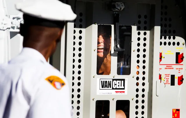 A protestor who was arrested yells from the back of a police van near the entrance to Quicken Loans Arena, site of the Republican National Convention in Cleveland, Ohio, USA, 20 July 2016. Donald Trump will formally accept the nomination of the Republican Party as their presidential candidate in the 2016 election during the four day convention which ends on Thursday. (Photo by Justin Lane/EPA)