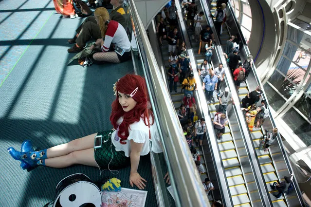 Arin Jade Mallin, dressed as a 'hipster' version of the Disney Little Mermaid fictional character Ariel, takes a rest during Comic Con 2016 in San Diego, California, USA, 22 July 2016. (Photo by David Maung/EPA)