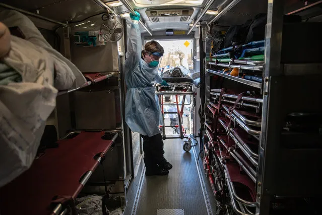 EMT Christian Amoroso, wearing personal protective equipment (PPE), pauses while unloading COVID-19 patients at the Montefiore Medical Center Wakefield Campus on April 06, 2020 in the Bronx borough of New York City. A specialized bus known as a Medical Evacuation Transport Unit (METU), caries infected patients on stretchers and benches between hospitals. The patient transfers are designed to help overwhelmed hospitals even out caseloads in Westchester County and New York City at the epicenter of the U.S. coronavirus pandemic. The patients were being transferred from the Einstein Campus, Wyler Hospital, also a Bronx Montefiore hospital. The transfers are staffed by Empress EMS, Yonkers police and hospital staff on both ends wearing PPE. (Photo by John Moore/Getty Images)
