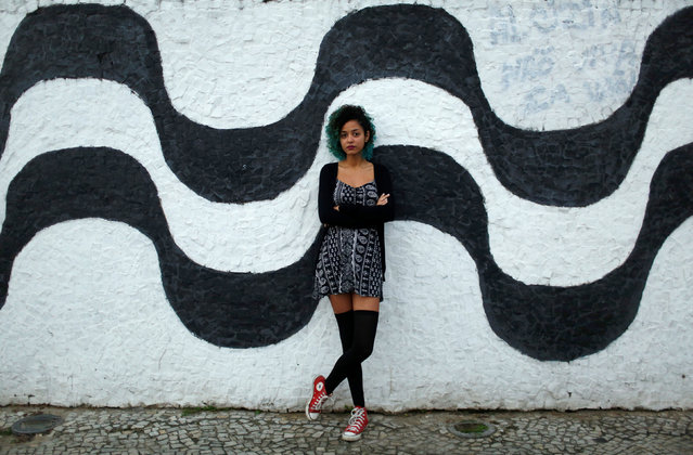 Aline Santos, a 23-year-old student, poses for a portrait in Rio de Janeiro, Brazil, July 23, 2016. When asked what she felt about Rio de Janeiro hosting the Olympics, Aline said, “For me the Olympics are synonymous with arbitrary because many people have been evicted from their houses for the construction of the Olympic Parks. I am totally against the Olympics”. (Photo by Pilar Olivares/Reuters)