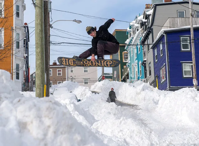A snowboarder takes advantage of prime conditions in St John’s, Canada on January 19, 2020. The state of emergency ordered by the City of St. John's continues, leaving businesses closed and vehicles off the roads in the aftermath of the major winter storm that hit the Newfoundland and Labrador capital. (Photo by Canadian Press/Rex Features/Shutterstock)