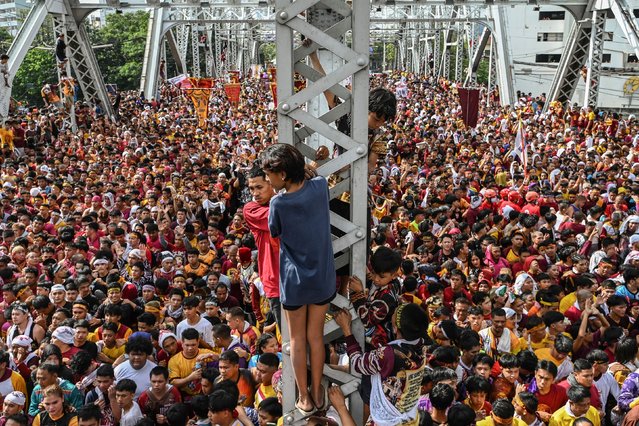 Catholic devotees attend the annual religious procession of the Black Nazarene in Manila on January 9, 2025. Hundreds of thousands of Catholic pilgrims swarmed the streets of Manila in search of a miracle on January 9, straining to reach a centuries-old statue of Jesus Christ in an annual display of religious fervour. (Photo by Jam Sta Rosa/AFP Photo)