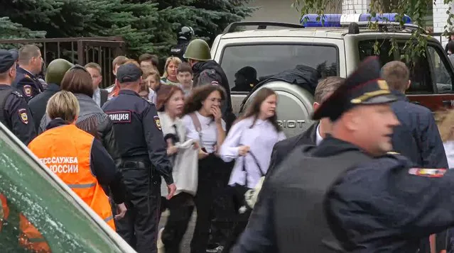 In this image taken from video, school children run from the scene of a shooting at school No. 88 in Izhevsk, Russia, Monday, September 26, 2022. (Photo by Izhlife.ru via AP Photo)