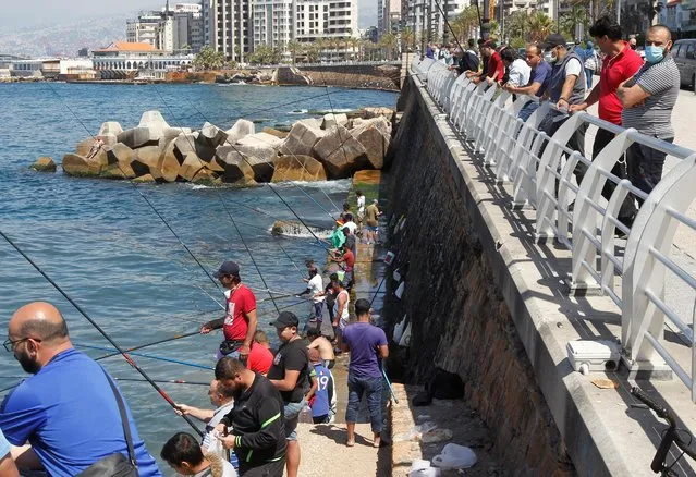 Fishermen dangle their lines to catch fish at Beirut's seaside Corniche, as Lebanese authorities warned of a new wave of the coronavirus disease (COVID-19) as the numbers jumped to the highest point in more than a month, after the government eased some restrictions on public life, in Beirut, Lebanon on May 10, 2020. (Photo by Mohamed Azakir/Reuters)
