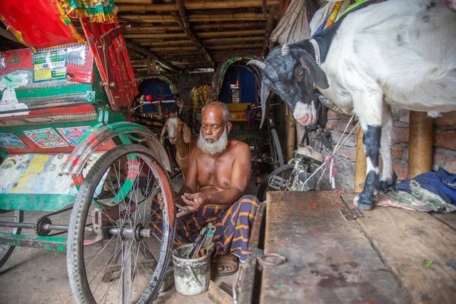 A man repairs a rickshaw at a garage in the Kalyanpur slum area in Dhaka, Bangladesh, 11 September 2022. The Kalyanpur slum is home to over 9,000 people, according to the BRAC non-governmental organization (NGO), which runs an urban development program there. A BRAC survey found that 21 percent of the slum dwellers arrived after being displaced by climate-related disasters. 'The impacts of climate change continue to take a huge economic and social toll on the people of Bangladesh', UN Special Rapporteur on the promotion and protection of human rights in the context of climate change, Ian Fry said. According to a World Bank report released in 2018, the number of people displaced by climate change in Bangladesh could reach 13.3 million by 2050, making it the country's number-one driver of internal migration. (Photo by Monirul Alam/EPA/EFE)