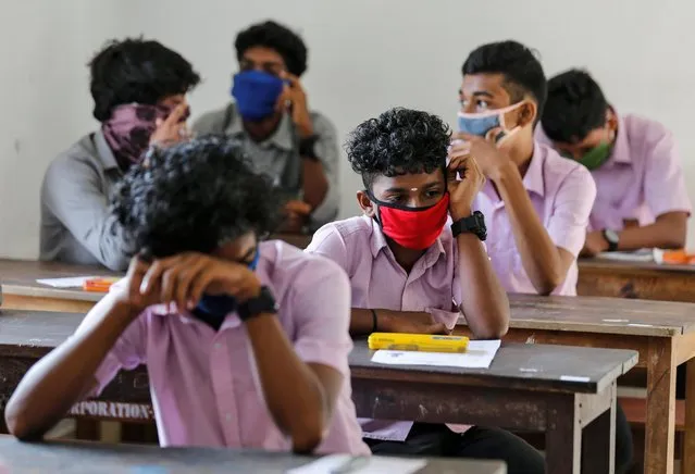 Students wearing protective masks wait for vocational higher secondary education exams which were postponed amid the coronavirus disease (COVID-19) spread, inside a school in Kochi, India, May 26, 2020. (Photo by Sivaram V/Reuters)