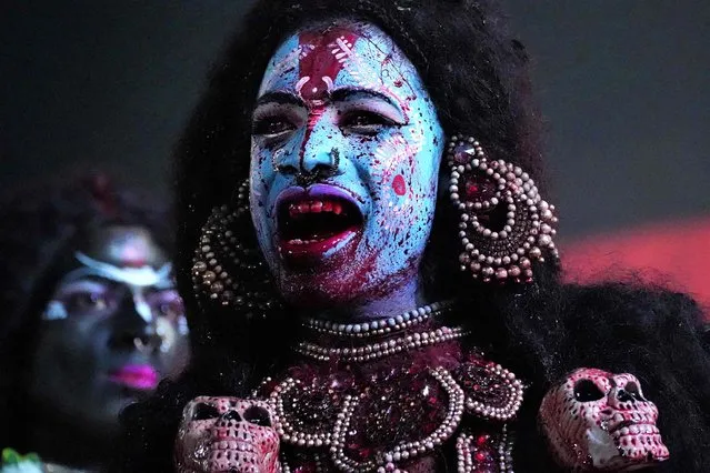 In this picture taken on October 1, 2022, a devotee performs in the guise of Hindu goddess Kali during “Durga Puja” festival celebrations in Ajmer. (Photo by Himanshu Sharma/AFP Photo)