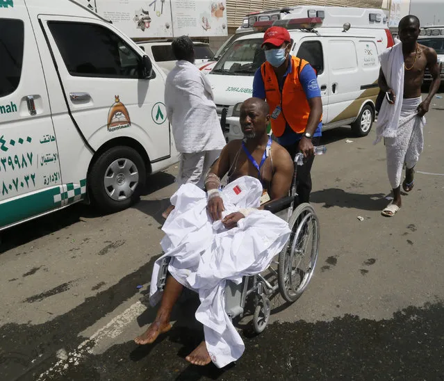 A rescue worker attends to a man injured in Mina, Saudi Arabia during the annual hajj pilgrimage on Thursday, September 24, 2015. (Photo by AP Photo)
