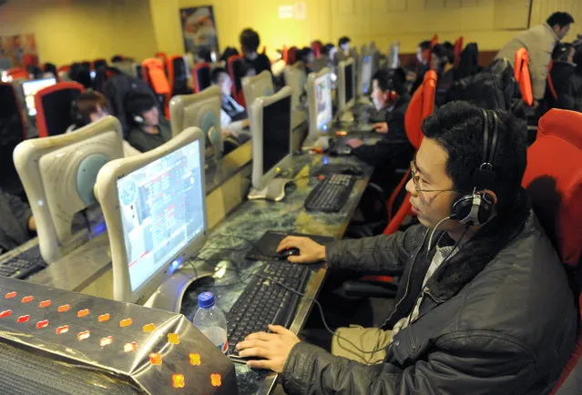 To go with feature story Lifestyle-China-IT-Internet-games by Joelle Garrus  A young man plays the online game at a internet cafe in Beijing on February 27, 2010. At one of Beijing's many Internet cafes, near-silence reigns: headphones on, eyes glued to the screen, web users play games online en masse, helping to make China one of the industry's top markets. (Photo by Liu Jin/AFP Photo)