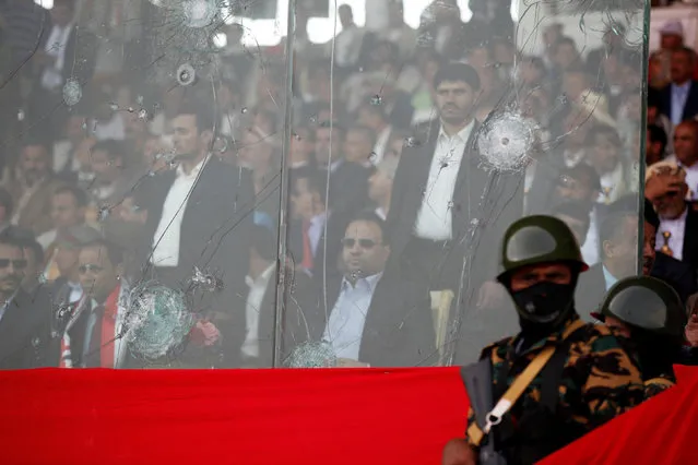 Saleh al-Sammad (C), who heads the Supreme Political Council, formed by the Houthi movement and the General People's Congress party to unilaterally rule Yemen by both groups, sits behind a bulletproof glass as he attends a rally held to show support to the council in the capital Sanaa August 20, 2016. (Photo by Khaled Abdullah/Reuters)