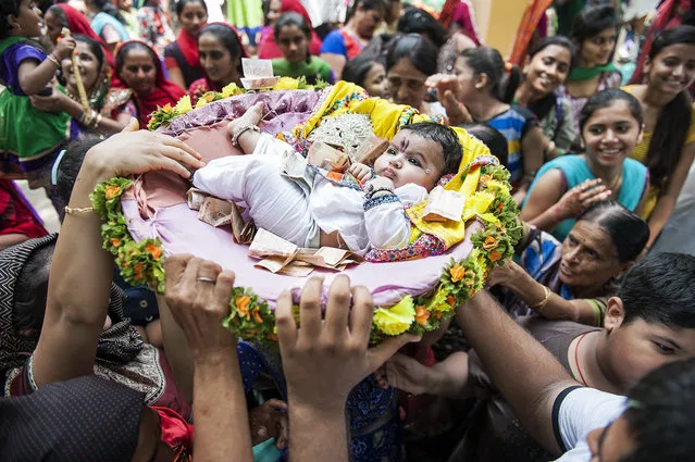 “Aahir”. Aahir peoples celebrating the Krishna festival. The baby which just born a week before the festival is considered the Krishna reincarnation. Photo location: Gujarat, India. (Photo and caption by Mattia Passarini/National Geographic Photo Contest)