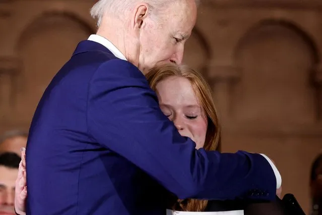 U.S. President Joe Biden embraces Jackie Hegarty, a Sandy Hook school shooting survivor during the 10th Annual National Vigil for All Victims of Gun Violence in Washington, U.S. December 7, 2022. (Photo by Jonathan Ernst/Reuters)