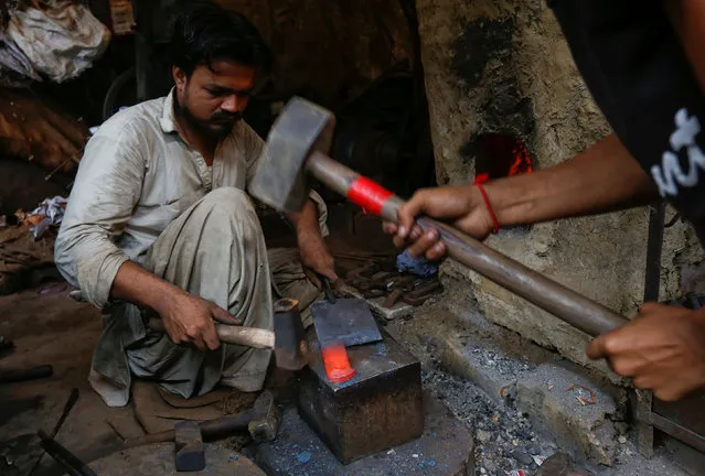 Men prepare butcher’s knife used for animal sacrifice ahead of the Eid al-Adha festival at a workshop in Karachi, Pakistan, September 12, 2016. (Photo by Akhtar Soomro/Reuters)