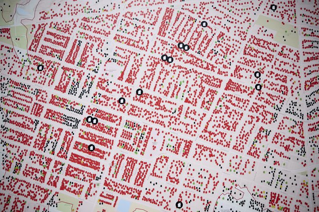 A map of destruction is on display during a press conference on the status of fire recovery efforts on the six month anniversary of the Eaton Fire in Altadena, California, USA, 07 July 2025. On the six month anniversary of the Eaton and Palisades fires, Governor Gavin Newsom today announced the substantial completion of the public debris removal program from more than 10,000 fire damaged parcels. (Photo by Allison Dinner/EPA)