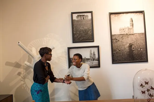 Illustrator and artist Sena Ahadji (R) chats with her friend Sharon at art gallery and shop La Maison in Accra, Ghana, July 23, 2015. (Photo by Francis Kokoroko/Reuters)