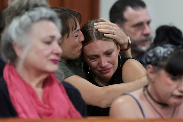Dylan Mortensen gets a hug after speaking at the sentencing hearing of Bryan Kohberger after he was convicted in the 2022 stabbing deaths of four Idaho college students, at the Ada County Courthouse, in Boise, Idaho on July 23, 2025. (Photo by Kyle Green/Pool via Reuters)