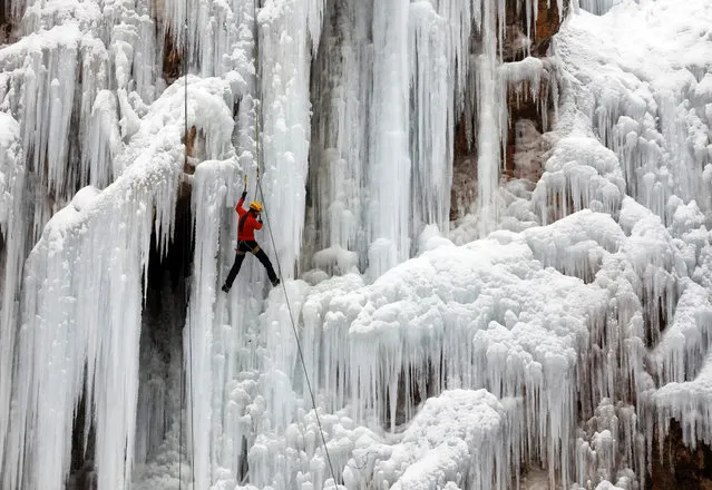 An Iranian ice climber scales an ice cliff and frozen waterfall at the Meygun ice climbing club, in the village of Meygun, northeast of the capital of Tehran, Iran, 26 January 2018. According to Mehid Panahipour, the owner of the school, every year around thousands of professionals and students attend the school, adding that government support would help the club host international competitions. (Photo by Abedin Taherkenareh/EPA/EFE)