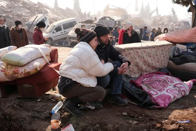 Sevde nur Zamir holds her husband Soner Zamir as they wait to find out if their loved ones are still alive, following the deadly earthquake in Maras, Turkey on February 11, 2023. (Photo by Emilie Madi/Reuters)