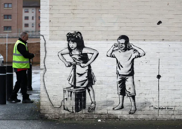 Art work by graffiti artist The Rebel Bear which has recently appeared showing two children about to detonate explosives at a cashline at a shopping centre in Cambuslang on September 30, 2020. Over recent months the artist has drawn several coronavirus related drawings in Glasgow. (Photo by Andrew Milligan/PA Images via Getty Images)