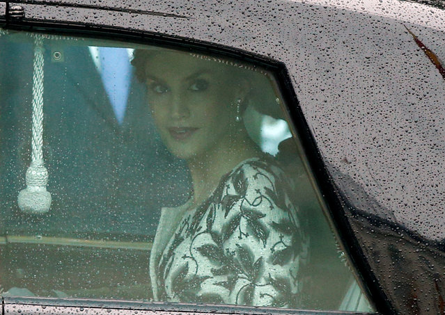 Queen Letizia of Spain looks through a window of a car after attending a military parade marking Spain's National Day in Madrid, Spain October 12, 2016. (Photo by Juan Medina/Reuters)