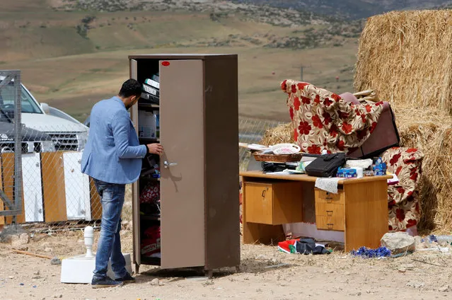 A Palestinian teacher checks a cupboard at the site of a school after Israeli forces removed structures used as classrooms, south of Hebron, in the occupied West Bank April 10, 2018. (Photo by Mussa Qawasma/Reuters)