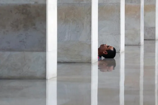 A Muslim man rests while waiting for iftar during the holy fasting month of Ramadan at the Grand Istiqlal Mosque in Jakarta, Indonesia on March 23, 2023. (Photo by Ajeng Dinar Ulfiana/Reuters)