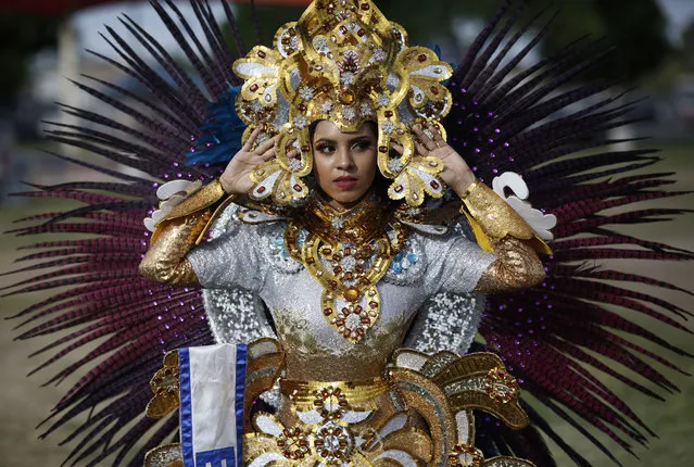 Keisy Medina adjusts her headdress on a costume representing El Salvador during a Cinco de Mayo festival in a park, Saturday, May 5, 2018, in North Las Vegas, Nev. (Photo by John Locher/AP Photo)