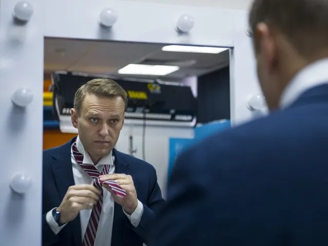 In this December 18, 2017, file photo, Russian opposition politician Alexei Navalny prepares himself prior his interview with The Associated Press in Moscow, Russia. The return of Navalny on Jan. 17, 2021, from Germany after he spent five months in Berlin recovering from a nerve agent poisoning was marked by chaos and popular outrage, and it ended, almost predictably with his arrest. (Photo by Alexander Zemlianichenko/AP Photo/File)
