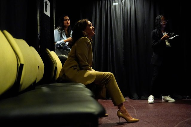 US Vice President and Democratic presidential candidate Kamala Harris sits backstage and listens to Minnesota Governor and Democratic vice presidential candidate Tim Walz speak during a a campaign event at Desert Diamond Arena in Phoenix, Arizona, on August 9, 2024. (Photo by Julia Nikhinson/Pool via AFP Photo)