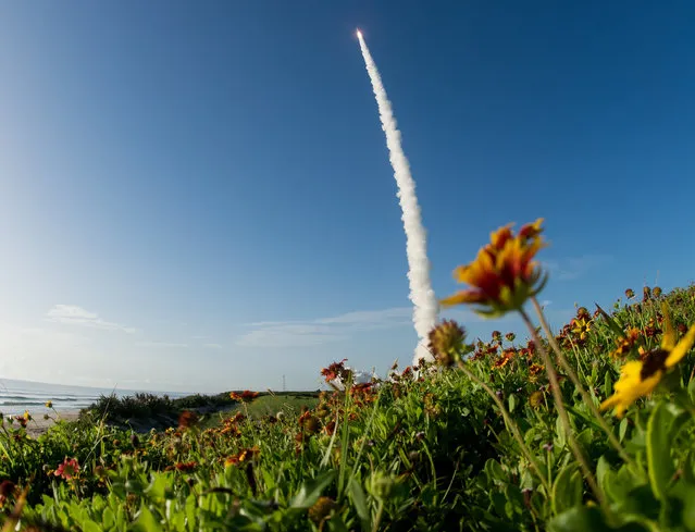 This NASA photo shows a United Launch Alliance Atlas V rocket with NASA’s Mars 2020 Perseverance rover onboard as it launches from Space Launch Complex 41 at Cape Canaveral Air Force Station, on July 30, 2020, from NASA’s Kennedy Space Center in Florida. The Perseverance rover is part of NASA’s Mars Exploration Program, a long-term effort of robotic exploration of the Red Planet. (Photo by Joel Kowsky/NASA)