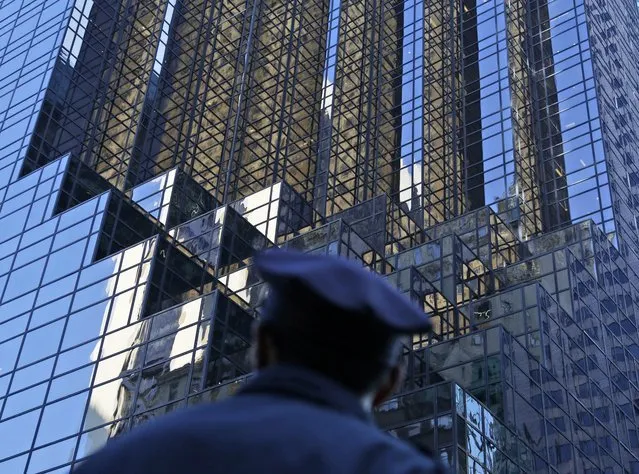 A police officer looks up at Trump Tower in New York, Thursday, November 17, 2016. (Photo by Seth Wenig/AP Photo)