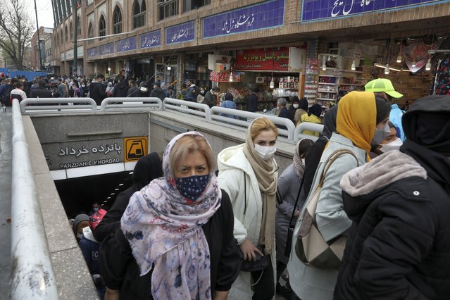 Mask-clad commuters leave a metro station at Tehran's Grand Bazaar, ahead of the Persian New Year, or Nowruz, meaning “New Day” in Iran, Monday, March 15, 2021. (Photo by Ebrahim Noroozi/AP Photo)