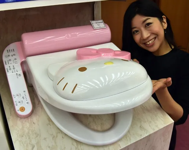 An employee for Japanese character goods maker Sanrio displays a prototype model of a Hello Kitty branded toilet seat at Sanrio's headquarters in Tokyo on February 2, 2015. The toilet seat has seat heating and warm water shower functions. (Photo by Yoshikazu Tsuno/AFP Photo)