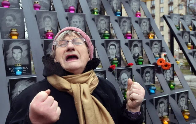 An elderly woman cries at the memorial for the killed Maidan activists during a ceremony marking the third anniversary of the Euromaidan beginning in central Kiev on November 21, 2016. Euromaidan, was a wave of demonstrations and civil unrest in Ukraine, which began on the night of 21 November 2013 with public protests at Independence Square in Kiev, demanding closer European integration. The scope of the protests expanded, with many calls for the resignation of President Viktor Yanukovych and his government. The protests led to the 2014 Ukrainian revolution. (Photo by Sergei Supinsky/AFP Photo)