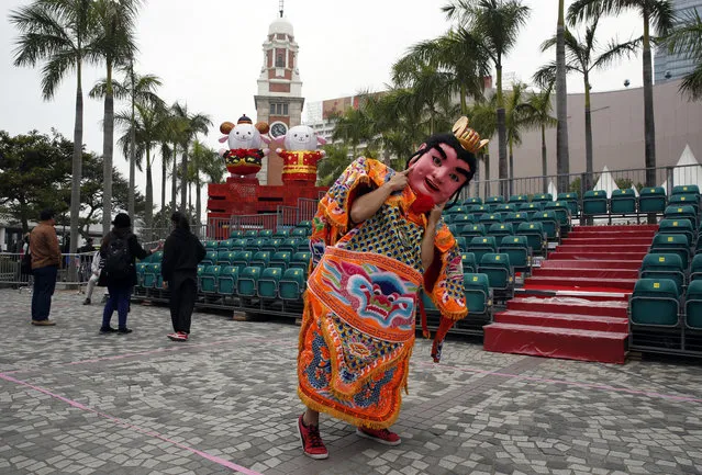 A performer from Taiwan dressed as the “Third Prince” poses for a photograph in front of the sheep decorations during the rehearsal of International Chinese New Year Night Parade in Hong Kong Wednesday, February 18, 2015. (Photo by Kin Cheung/AP Photo)