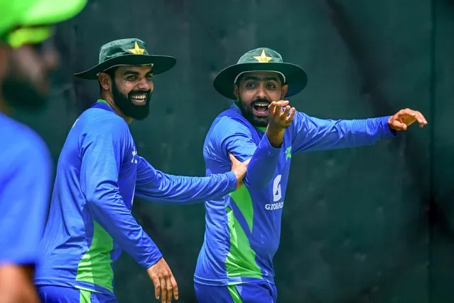 Pakistan's captain Babar Azam (R) and Shadab Khan gesture during a practice session at the R. Premadasa Stadium in Colombo on September 9, 2023, on the eve of their Asia Cup super four cricket match against India. (Photo by Ishara S. Kodikara/AFP Photo)