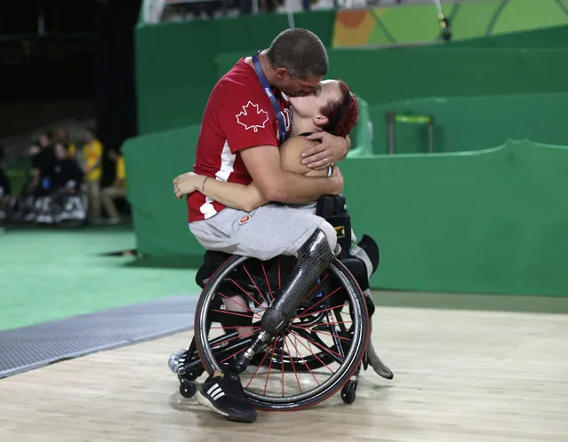 Canada's men's wheelchair basketball team player Adam Lancia embraces his wife Jamey Jewells of Canada after her women's wheelchair basketball playoff match against China at the Rio Paralympics September 16, 2016. (Photo by Ueslei Marcelino/Reuters)