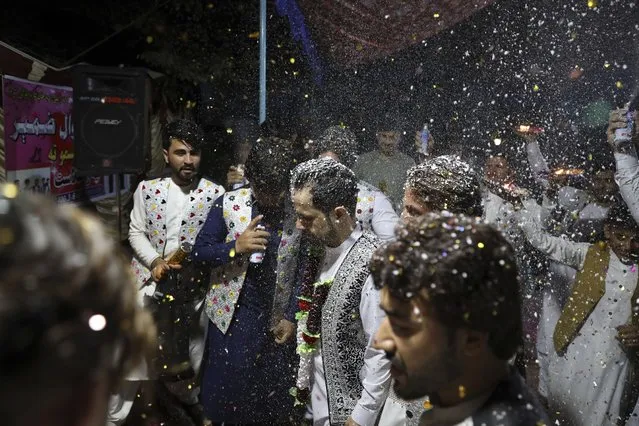 Zameer Ahmad, an Afghan groom, center, celebrates his wedding with friends at his home in the city of Jalalabad east of Kabul, Afghanistan, Friday, May 28, 2021. (Photo by Rahmat Gul/AP Photo)