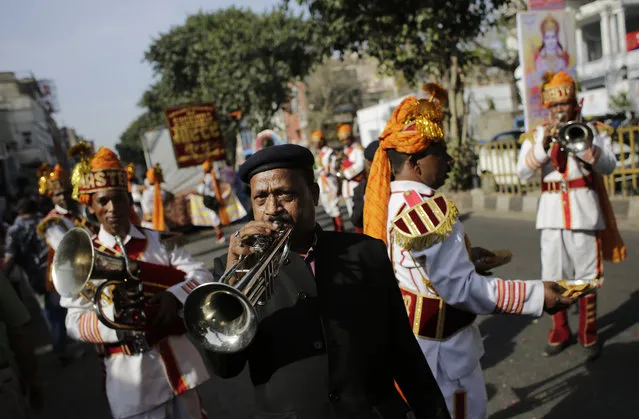 Members of a brass band play religious tunes during in a religious procession on Ram Navami festival in New Delhi, India, Saturday, March 28, 2015. (Photo by Altaf Qadri/AP Photo)