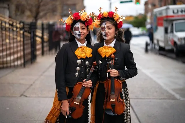 People take part in a Day of the Dead Parade in the Sunset Park neighborhood of Brooklyn in New York on October 29, 2023. (Photo by Adam Gray/AFP Photo)
