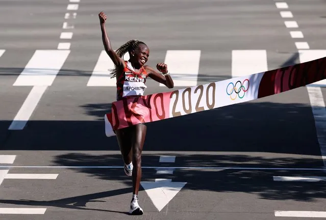 Peres Jepchirchir of Team Kenya celebrates as she crosses the finish line to win the gold medal in the Women's Marathon Final on day fifteen of the Tokyo 2020 Olympic Games at Sapporo Odori Park on August 7, 2021 in Sapporo, Japan. (Photo by Kim Hong-Ji/Reuters)