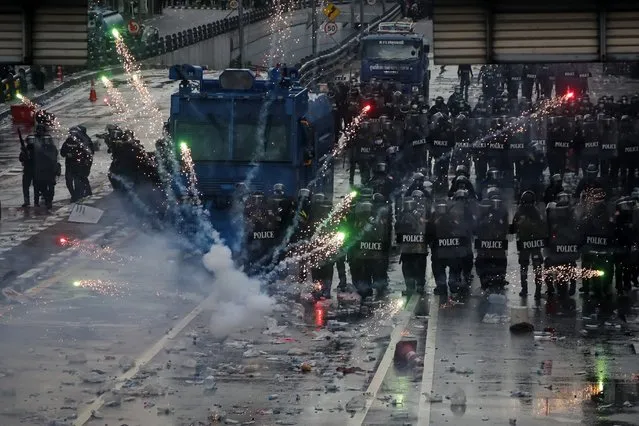 A projectile explodes in front of a line of riot police as they try to disperse anti-government protesters on August 07, 2021 in Bangkok, Thailand. Local media reported that the police will deploy at least 5,700 officers to ensure public order and security during Saturday's anti-government rally in the capital, which was originally scheduled to be held near the Grand Palace, but was changed. Protests have continued in the Thai capital despite record numbers of Covid-19 infections. (Photo by Lauren DeCicca/Getty Images)