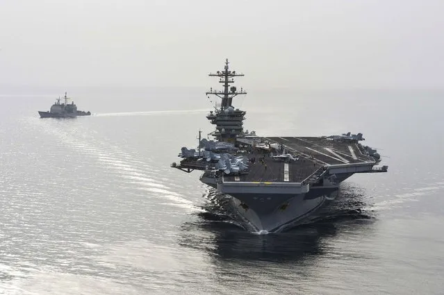 The aircraft carrier USS Theodore Roosevelt (CVN 71) and the guided-missile cruiser USS Normandy (CG) 60 sail in the Arabian Sea, in this U.S. Navy photo taken April 16, 2015. The ships will join seven other U.S. warships in the waters near Yemen, which is torn by civil strife as Iranian-backed Houthi rebels battle forces loyal to the U.S.-backed president. (Photo by Mass Communication Specialist Seaman Anna Van Nuys/Reuters/U.S. Navy)