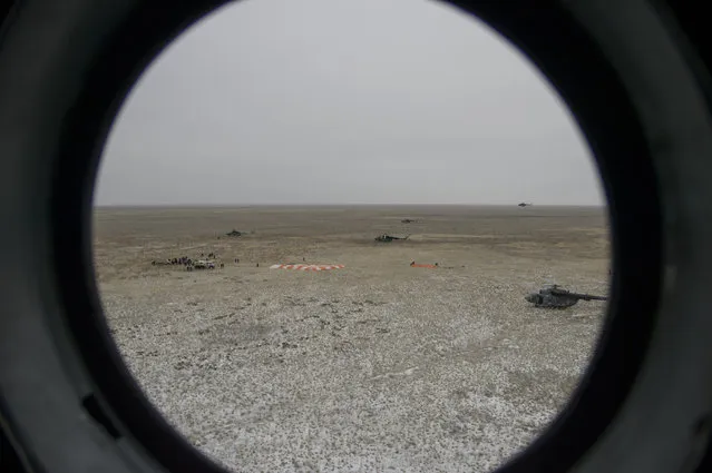 In this handout provided by NASA, The Soyuz TMA-18M spacecraft landing site is seen through the window of an arriving Russian MI-8 helicopter after Expedition 46 Commander Scott Kelly of NASA and Russian cosmonauts Mikhail Kornienko and Sergey Volkov of Roscosmos landed in their capsule on March 2, 2016 near the town of Zhezkazgan, Kazakhstan. (Photo by Bill Ingalls/NASA via Getty Images)