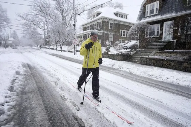 Nelson Taylor, of Providence, R.I., uses cross-country skis while making his way along a residential street, Tuesday, February 13, 2024, in Providence. Parts of the Northeast have been hit by a coastal storm that's dumping snow and packing strong winds in some areas, while others aren't getting as much snow as anticipated. (Photo by Steven Senne/AP Photo)